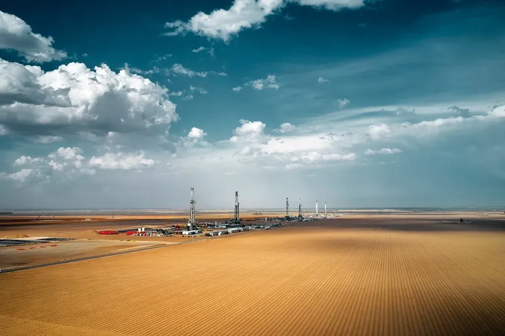 West Texas oil field landscape showing multiple drilling rigs across the Permian Basin. Landman uses this industrial aesthetic to frame petroleum extraction as both economic necessity and frontier mythology, central to Sheridan's thematic architecture.