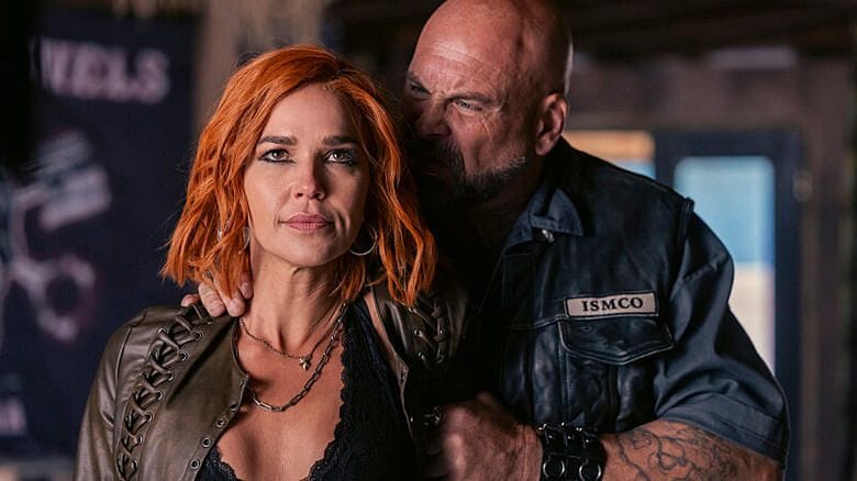 Belle Skinner held by motorcycle gang member