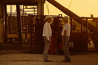 Tommy and T.L. standing at an oil-field site in Landman