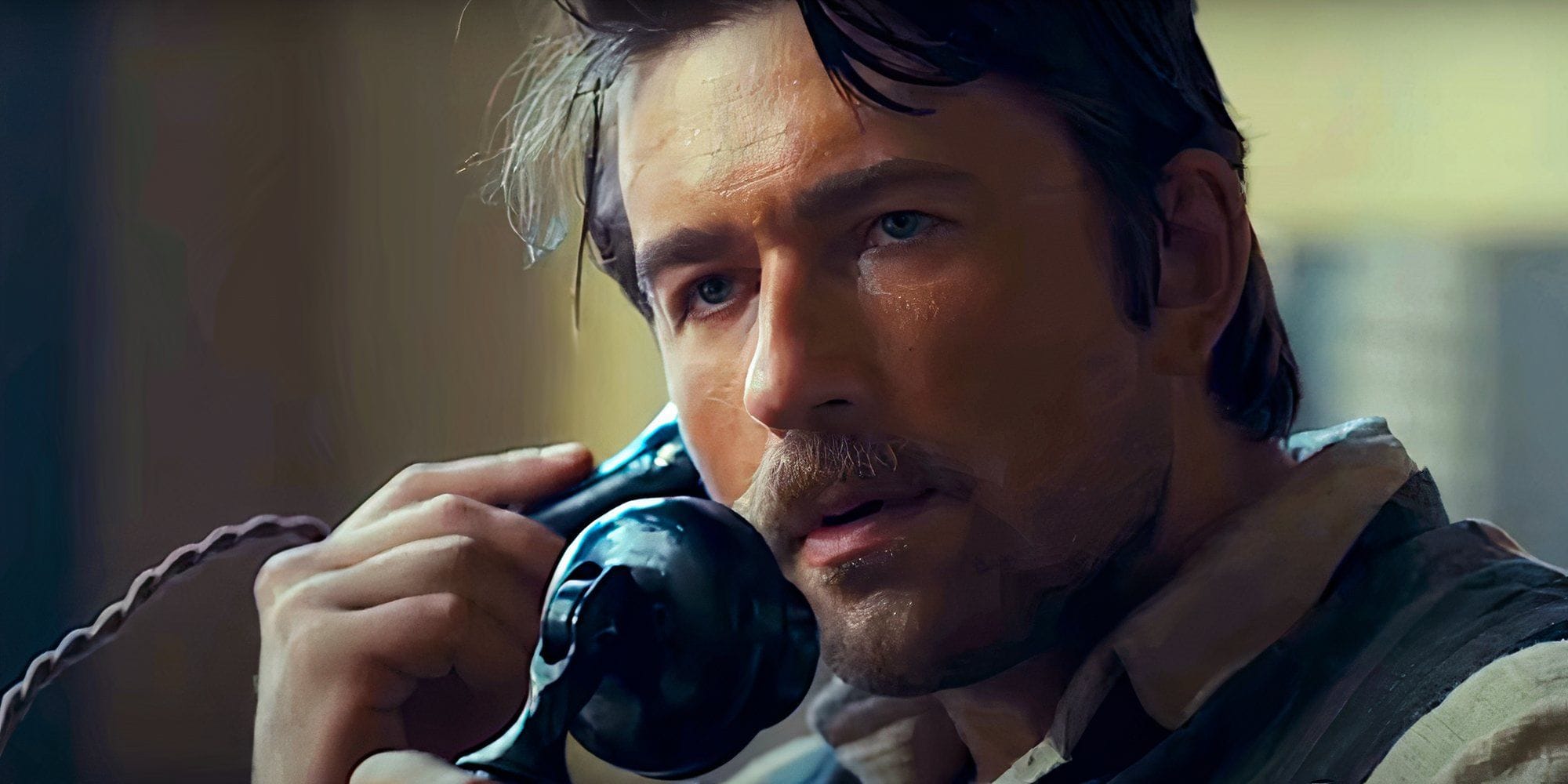 Brandon Sklenar as Spencer Dutton urgently on the phone in 1923 Season 2 — fighting his way back to Montana across post-war Europe. (Image: Paramount+/Screen Rant)